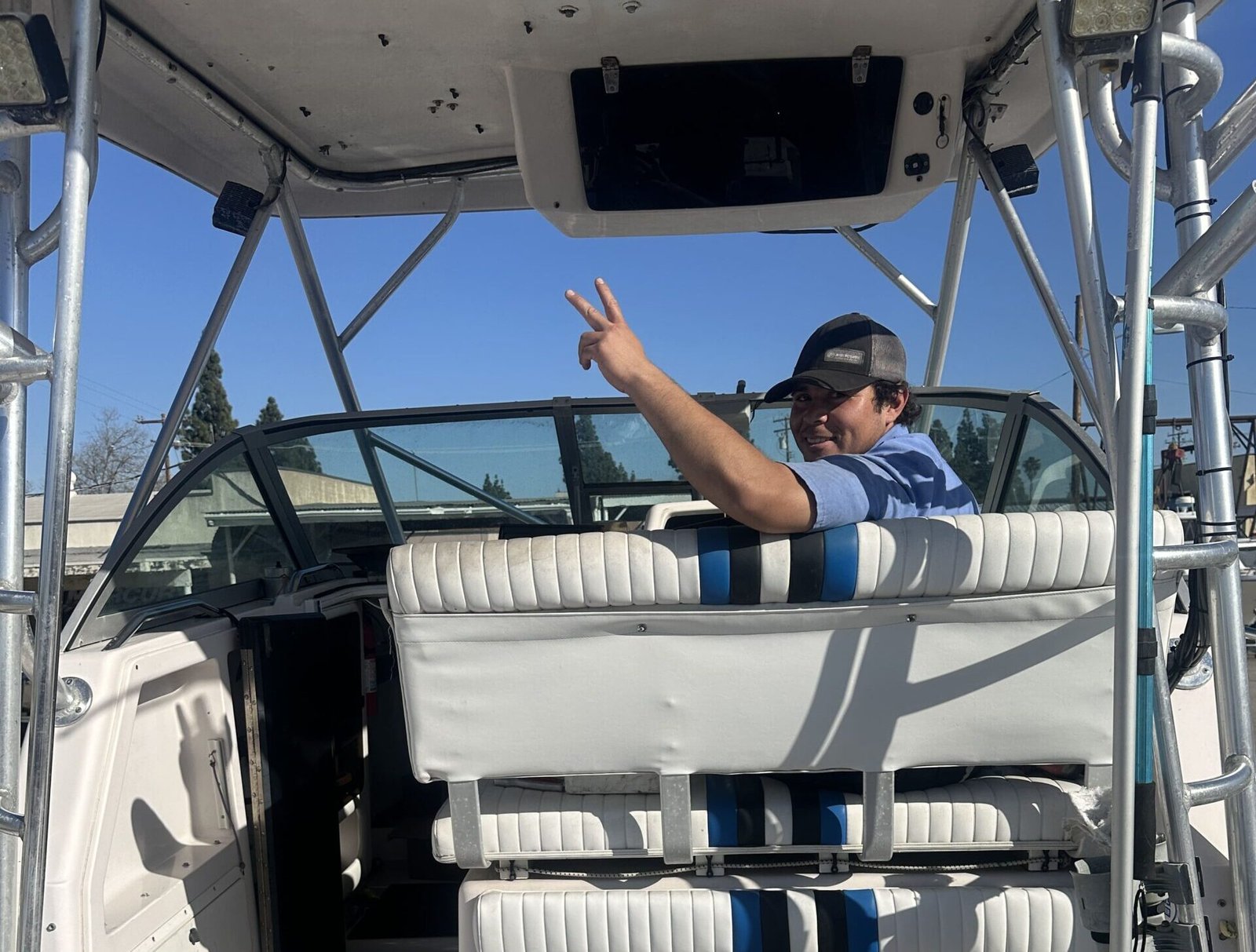 Marine technician sitting near the steering wheel